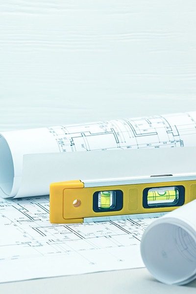 architect drawing with level on desk